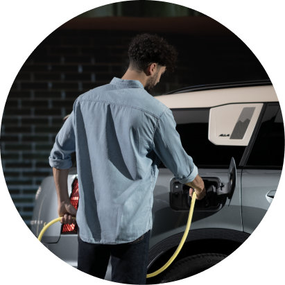 A man charges his MINI Countryman SE ALL4. 