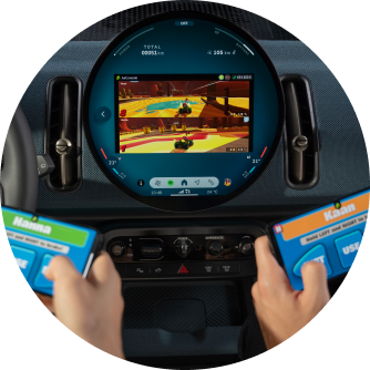 Two passengers play a video game on the MINI OLED Display via Available AirConsole while parked.