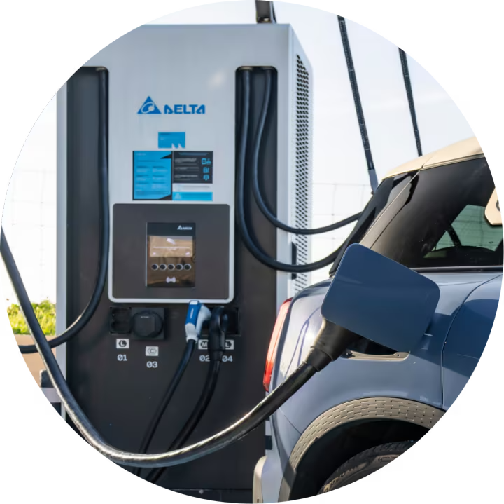 Side view of the rear of a MINI recharging at a public charging station.