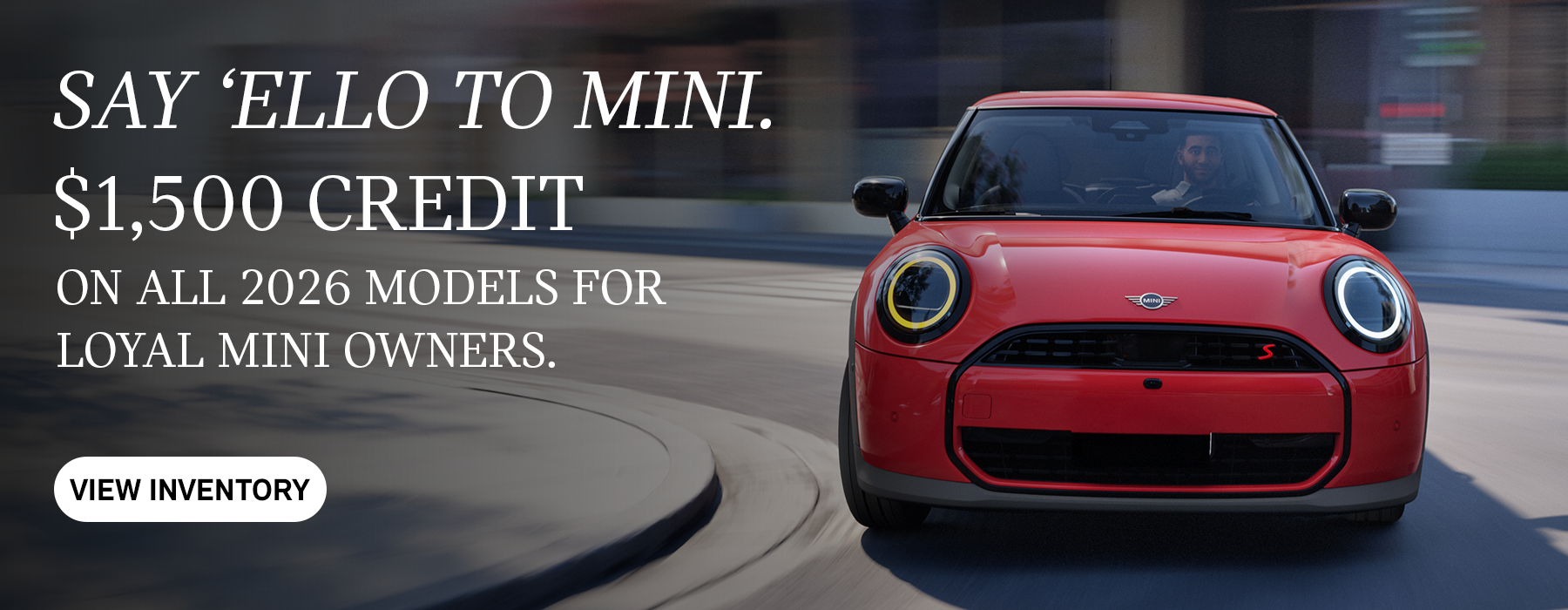 Front view of red MINI cooper curving corner.