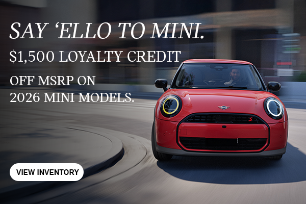 Front view of red MINI cooper curving corner.