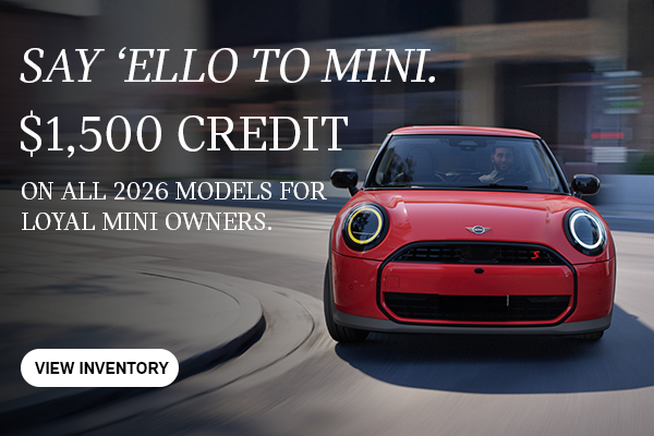 Front view of red MINI cooper curving corner.